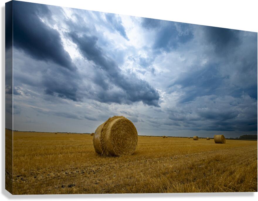 Hay Bales Under a Cloudy Sky Canvas Print