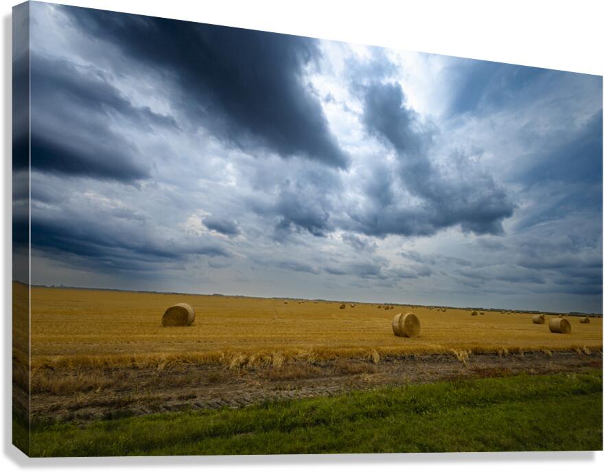 Hay Bales Under a Cloudy Sky Canvas Print