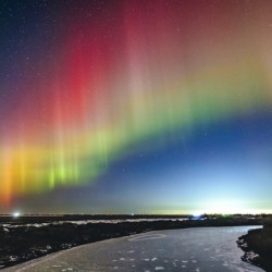 Rainbow Auroras Over The Red River