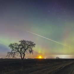 Moonrise Under Northern Lights
