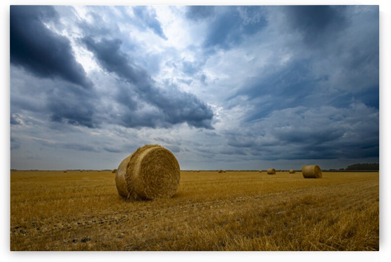 Hay Bales Under a Cloudy Sky by Marc Gilbert Photography