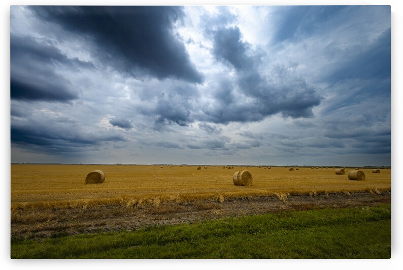 Hay Bales Under a Cloudy Sky by Marc Gilbert Photography